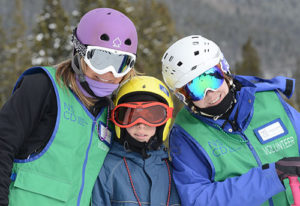 Photo of disabled skier and NSCD Volunteers